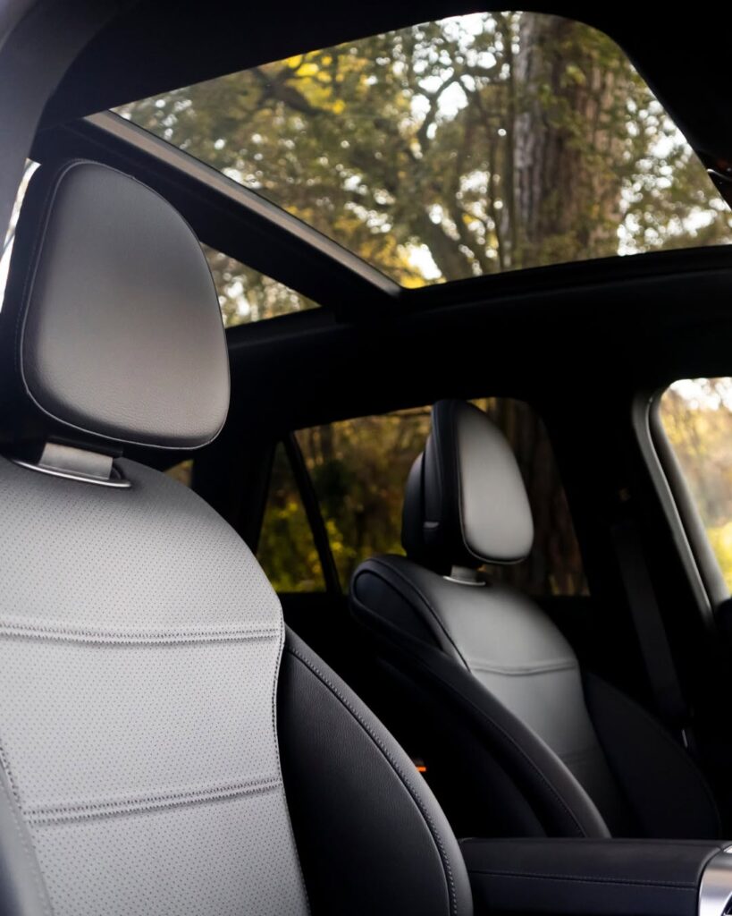 Interior of the Mercedes-Benz GLC Coupe featuring premium perforated leather seats and a large panoramic sunroof, offering tailored, high-end comfort.