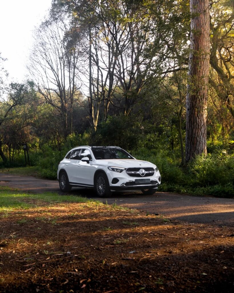 White Mercedes-Benz GLC Coupe parked on a scenic forest road, illustrating why this versatile vehicle is not just another soft-roader